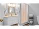 Bathroom with a white vanity, shower, and wicker storage, combining style with practical storage solutions at 4004 Bamburgh Ln, Apex, NC 27539
