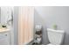 Bathroom featuring a shower, toilet, and storage shelves, creating a clean and organized space at 4004 Bamburgh Ln, Apex, NC 27539