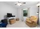 Cozy bedroom with chair and window for natural light at 4004 Bamburgh Ln, Apex, NC 27539