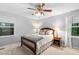 Comfortable bedroom features neutral walls, soft carpet, and a decorative ceiling fan at 4004 Bamburgh Ln, Apex, NC 27539