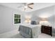 Cozy bedroom featuring a ceiling fan, window, and comfortable furnishings at 4004 Bamburgh Ln, Apex, NC 27539