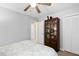 Bedroom with ceiling fan, closet and display cabinet for storage at 4004 Bamburgh Ln, Apex, NC 27539