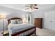 Well-lit bedroom with neutral walls, carpet, dark wood furniture, and bright window at 4004 Bamburgh Ln, Apex, NC 27539