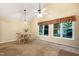Open dining area with a glass table beneath a vaulted ceiling, providing ample natural light at 4004 Bamburgh Ln, Apex, NC 27539