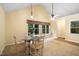 Sunlit dining area features a glass table, carpet, and large windows at 4004 Bamburgh Ln, Apex, NC 27539