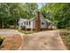 Charming home with blue siding, brick accents, lush landscaping, and an expansive driveway at 4004 Bamburgh Ln, Apex, NC 27539