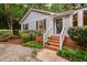 Inviting home entrance with brick steps, white railings, and neat landscaping at 4004 Bamburgh Ln, Apex, NC 27539