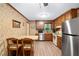 Traditional eat-in kitchen features stainless steel appliances and wood cabinets, blending functionality with classic style at 4004 Bamburgh Ln, Apex, NC 27539