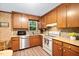 Functional kitchen with warm wood cabinets, stainless steel appliances, and ample counter space at 4004 Bamburgh Ln, Apex, NC 27539