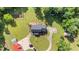 Aerial image featuring the home, the driveway, garden, and the mature landscaping at 4024 Rural Retreat Rd, Burlington, NC 27215
