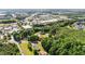 Aerial view of the property surrounded by lush green trees and featuring nearby retail shopping centers at 4024 Rural Retreat Rd, Burlington, NC 27215