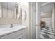 Bathroom features a single vanity with an open door leading to a room with checkerboard floors at 4024 Rural Retreat Rd, Burlington, NC 27215