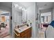 Well-lit bathroom featuring a vanity, ample counter space, and convenient access to other rooms at 4024 Rural Retreat Rd, Burlington, NC 27215