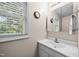 Bathroom includes a single vanity, a mirror, and a window bringing in natural light at 4024 Rural Retreat Rd, Burlington, NC 27215
