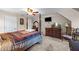 Bedroom featuring a four-poster bed, carpet, and a television mounted to the wall at 4024 Rural Retreat Rd, Burlington, NC 27215