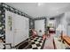 Welcoming foyer with black and white checkered floors and floral wallpaper at 4024 Rural Retreat Rd, Burlington, NC 27215