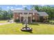 Stately brick home boasts a charming front yard and fountain focal point at 4024 Rural Retreat Rd, Burlington, NC 27215