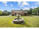 Brick home with a circular driveway and a decorative water fountain in the front yard at 4024 Rural Retreat Rd, Burlington, NC 27215