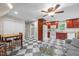 Eat-in kitchen boasts checkerboard floors, wooden cabinets, white appliances, and an eat-in table at 4024 Rural Retreat Rd, Burlington, NC 27215