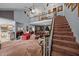 Open living area with high ceilings, staircase, and eclectic decor for a unique and inviting space at 4024 Rural Retreat Rd, Burlington, NC 27215