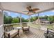 Covered porch with chairs overlooks a lush green yard with mature trees and a brick home at 4024 Rural Retreat Rd, Burlington, NC 27215