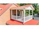 Outdoor deck with red metal roofing, white railings, and furniture at 4024 Rural Retreat Rd, Burlington, NC 27215