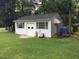 A white shed offers extra storage and matches the charming exterior at 4024 Rural Retreat Rd, Burlington, NC 27215