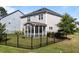 A fenced backyard with a screened porch offers a private outdoor space perfect for relaxation and entertainment at 408 Torwood Cir, Apex, NC 27523