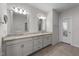 Elegant bathroom featuring a double vanity with granite countertop and tile flooring, leading to shower room at 408 Torwood Cir, Apex, NC 27523