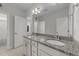 Bright bathroom with double sinks, granite countertops, and white cabinets, enhanced by a large mirror at 408 Torwood Cir, Apex, NC 27523