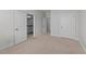 Neutral bedroom doorway view showcasing carpeted floors, white trim, and access to bathrooms at 408 Torwood Cir, Apex, NC 27523