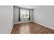Simple bedroom with natural light and hardwood floors at 408 Torwood Cir, Apex, NC 27523