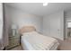 Cozy bedroom featuring a comfortable bed, side table with lamp, and a door to the bathroom at 408 Torwood Cir, Apex, NC 27523