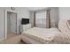 Comfortable bedroom with a large window, television and side table with lamp for a cozy retreat at 408 Torwood Cir, Apex, NC 27523