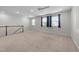 Spacious bonus room with neutral carpet, large windows, ceiling fan and stylish wood and white trim at 408 Torwood Cir, Apex, NC 27523