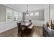Elegant dining room with hardwood floors and natural light, flowing seamlessly into adjacent living areas at 408 Torwood Cir, Apex, NC 27523