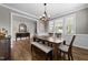 Dining area featuring natural light, complemented by hardwood floors and an elegant transition to the living spaces at 408 Torwood Cir, Apex, NC 27523