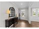 Elegant foyer with a decorative mirror, hardwood floors, and a view of the home's entryway and living spaces at 408 Torwood Cir, Apex, NC 27523