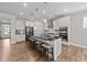Modern kitchen with a large island, stainless steel appliances, and ample counter space for culinary creations at 408 Torwood Cir, Apex, NC 27523