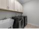 A well-organized laundry room with modern washer and dryer, plus convenient storage cabinets at 408 Torwood Cir, Apex, NC 27523