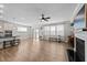 Spacious living room with fireplace and large windows adjacent to the kitchen area at 408 Torwood Cir, Apex, NC 27523