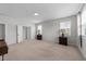 Spacious main bedroom with neutral paint and carpeting, featuring ample natural light and two side tables with lamps at 408 Torwood Cir, Apex, NC 27523