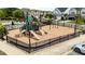Fenced-in community playground with slides, swings, and ample space for children to play at 408 Torwood Cir, Apex, NC 27523