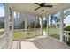 Relaxing screened porch with a ceiling fan and views of the well-maintained backyard and neighborhood at 408 Torwood Cir, Apex, NC 27523
