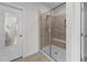 Modern bathroom shower with a tiled surround, glass door, and built-in bench for a luxurious experience at 408 Torwood Cir, Apex, NC 27523