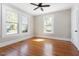 Bedroom showcasing hardwood floors, multiple windows, and ample natural light at 409 N Hyde Park Ave, Durham, NC 27703