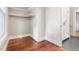 Walk-in closet with hardwood floors, window, and built-in shelves at 409 N Hyde Park Ave, Durham, NC 27703