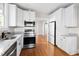 Updated kitchen features stainless appliances, granite countertops, and white cabinets at 409 N Hyde Park Ave, Durham, NC 27703