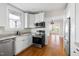 Updated kitchen features stainless appliances, granite countertops, and white cabinets at 409 N Hyde Park Ave, Durham, NC 27703