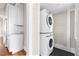 Convenient laundry area with stacked washer and dryer and built in cabinets at 409 N Hyde Park Ave, Durham, NC 27703